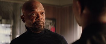 Movie still from “Shaft” (2019), directed by Tim Story – A man with a beard is looking into the distance; Close Up shot, Over the shoulder angle
