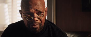 Movie still from “Shaft” (2019), directed by Tim Story – A bald man with glasses is looking at the camera; Close Up shot, Low angle