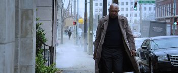 Movie still from “Shaft” (2019), directed by Tim Story – A man walking down the street wearing a trench coat; Medium shot, Low angle