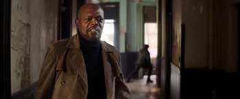 Movie still from “Shaft” (2019), directed by Tim Story – An older man wearing a brown jacket and a black sweater; Medium shot, Low angle