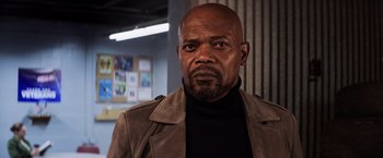 Movie still from “Shaft” (2019), directed by Tim Story – A man in a brown jacket is looking at the camera; Close Up shot, Low angle