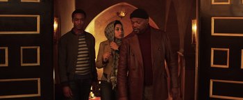 Movie still from “Shaft” (2019), directed by Tim Story – Two men and a woman standing next to each other in front of an archway; Medium shot, Low angle