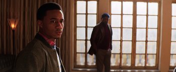 Movie still from “Shaft” (2019), directed by Tim Story – Two men standing next to each other in front of a window; Medium shot, Over the shoulder angle