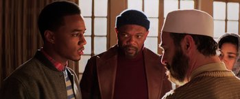 Movie still from “Shaft” (2019), directed by Tim Story – A group of men standing next to each other in front of a window; Close Up shot, Over the shoulder angle