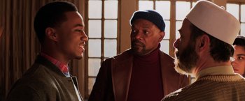Movie still from “Shaft” (2019), directed by Tim Story – Two men talking to each other in front of a window; Medium shot, Over the shoulder angle