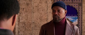 Movie still from “Shaft” (2019), directed by Tim Story – An older man wearing a hat and a brown jacket; Close Up shot, Over the shoulder angle