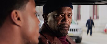 Movie still from “Shaft” (2019), directed by Tim Story – A man in a leather jacket and a woman in a black hat; Close Up shot, Over the shoulder angle