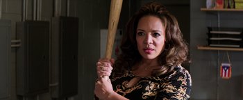 Movie still from “Shaft” (2019), directed by Tim Story – A woman holding a wooden baseball bat in her hands; Close Up shot, Over the shoulder angle