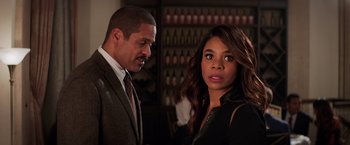 Movie still from “Shaft” (2019), directed by Tim Story – A man and a woman standing next to each other in a room; Close Up shot, Over the shoulder angle