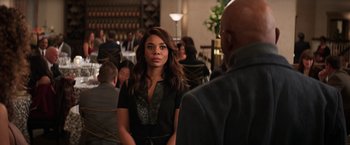 Movie still from “Shaft” (2019), directed by Tim Story – A woman standing next to a man in a restaurant; Medium shot, Over the shoulder angle