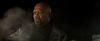 Movie still from “Shaft” (2019), directed by Tim Story – A bald man with a black jacket and a black shirt; Close Up shot, Low angle