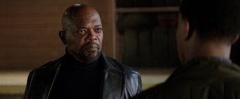 Movie still from “Shaft” (2019), directed by Tim Story – A man in a leather jacket looking to his left; Close Up shot, Over the shoulder angle
