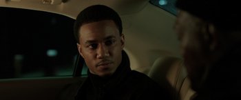 Movie still from “Shaft” (2019), directed by Tim Story – A man sitting in the back seat of a car; Close Up shot, Over the shoulder angle