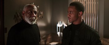 Movie still from “Shaft” (2019), directed by Tim Story – Two men standing next to each other in a room; Medium shot, Over the shoulder angle