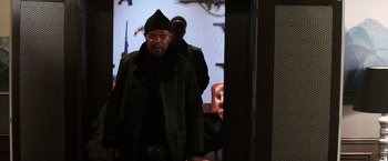Movie still from “Shaft” (2019), directed by Tim Story – A man in a black coat and a black hat; Medium shot, Over the shoulder angle