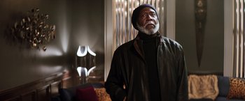 Movie still from “Shaft” (2019), directed by Tim Story – An older man standing in front of a mirror; Medium shot, Low angle