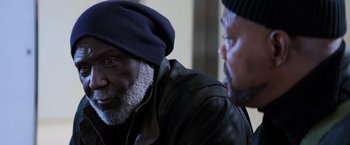 Movie still from “Shaft” (2019), directed by Tim Story – A man wearing a hat and a leather jacket is talking to another man; Close Up shot, Over the shoulder angle