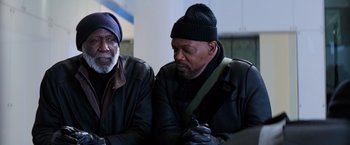 Movie still from “Shaft” (2019), directed by Tim Story – Two older men sitting next to each other on a bench; Medium shot, Over the shoulder angle