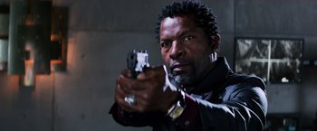 Movie still from “Shaft” (2019), directed by Tim Story – A man holding a gun in his hand; Close Up shot, Low angle