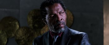 Movie still from “Shaft” (2019), directed by Tim Story – A man in a suit and tie looking at the camera; Close Up shot, Low angle