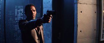 Movie still from “Shaft” (2019), directed by Tim Story – A man holding a gun in a room; Close Up shot, Over the shoulder angle