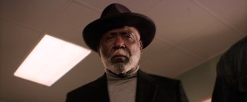 Movie still from “Shaft” (2019), directed by Tim Story – An older man wearing a black hat and a black jacket; Close Up shot, Low angle