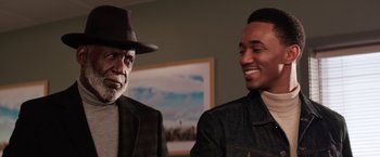 Movie still from “Shaft” (2019), directed by Tim Story – A man in a hat standing next to a man in a jean jacket; Close Up shot, Over the shoulder angle
