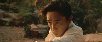Movie still from “Shang-Chi and the Legend of the Ten Rings” (2021), directed by Destin Daniel Cretton – A person wearing a white shirt; Close Up shot, Low angle