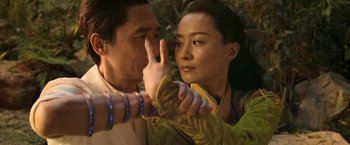 Movie still from “Shang-Chi and the Legend of the Ten Rings” (2021), directed by Destin Daniel Cretton – A man and a woman are holding hands and looking at each other; Close Up shot, Over the shoulder angle