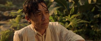 Movie still from “Shang-Chi and the Legend of the Ten Rings” (2021), directed by Destin Daniel Cretton – A person wearing a white shirt; Close Up shot, Low angle