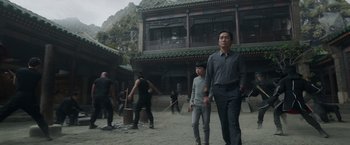 Movie still from “Shang-Chi and the Legend of the Ten Rings” (2021), directed by Destin Daniel Cretton – A group of people are playing a game in the middle of a courtyard; Medium shot, Low angle