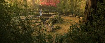 Movie still from “Shang-Chi and the Legend of the Ten Rings” (2021), directed by Destin Daniel Cretton – A small waterfall in a lush green forest; Extreme Wide shot, High angle