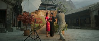 Movie still from “Shang-Chi and the Legend of the Ten Rings” (2021), directed by Destin Daniel Cretton – A man and a woman posing for a picture; Wide shot, Low angle