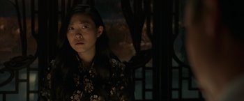 Movie still from “Shang-Chi and the Legend of the Ten Rings” (2021), directed by Destin Daniel Cretton – A young girl in a floral dress looking at the camera; Close Up shot, Over the shoulder angle