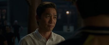 Movie still from “Shang-Chi and the Legend of the Ten Rings” (2021), directed by Destin Daniel Cretton – A person wearing a white shirt; Close Up shot, Over the shoulder angle