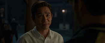 Movie still from “Shang-Chi and the Legend of the Ten Rings” (2021), directed by Destin Daniel Cretton – A person wearing a white shirt; Close Up shot, Over the shoulder angle