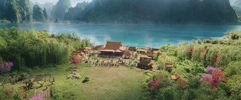 Movie still from “Shang-Chi and the Legend of the Ten Rings” (2021), directed by Destin Daniel Cretton – An aerial view of an asian village with a lake in the background; Extreme Wide shot, High angle