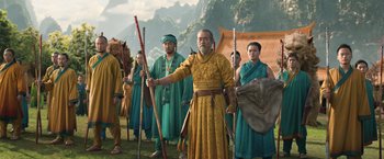 Movie still from “Shang-Chi and the Legend of the Ten Rings” (2021), directed by Destin Daniel Cretton – A group of people dressed in ancient clothing; Wide shot, Low angle