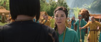 Movie still from “Shang-Chi and the Legend of the Ten Rings” (2021), directed by Destin Daniel Cretton – A woman in a green shirt talking to another woman; Close Up shot, Over the shoulder angle