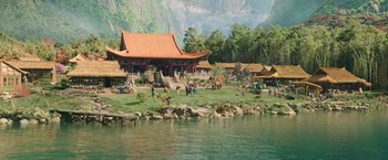 Movie still from “Shang-Chi and the Legend of the Ten Rings” (2021), directed by Destin Daniel Cretton – A group of people standing on top of a grass covered field; Extreme Wide shot, High angle