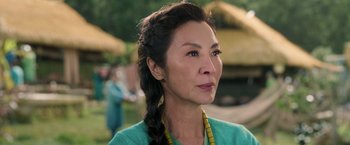 Movie still from “Shang-Chi and the Legend of the Ten Rings” (2021), directed by Destin Daniel Cretton – An asian woman with a long braid looking to her left; Close Up shot, Over the shoulder angle