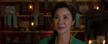 Movie still from “Shang-Chi and the Legend of the Ten Rings” (2021), directed by Destin Daniel Cretton – A person wearing a green shirt; Close Up shot, Over the shoulder angle