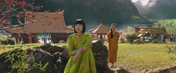Movie still from “Shang-Chi and the Legend of the Ten Rings” (2021), directed by Destin Daniel Cretton – Two asian women standing next to each other in a field; Medium shot, Over the shoulder angle