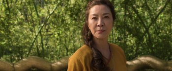 Movie still from “Shang-Chi and the Legend of the Ten Rings” (2021), directed by Destin Daniel Cretton – A person wearing a yellow shirt; Close Up shot, Over the shoulder angle