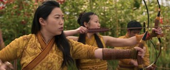 Movie still from “Shang-Chi and the Legend of the Ten Rings” (2021), directed by Destin Daniel Cretton – Two asian women in traditional clothing are practicing archery; Medium shot, Over the shoulder angle