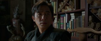 Movie still from “Shang-Chi and the Legend of the Ten Rings” (2021), directed by Destin Daniel Cretton – A person in a room; Close Up shot, Over the shoulder angle