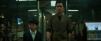 Movie still from “Shang-Chi and the Legend of the Ten Rings” (2021), directed by Destin Daniel Cretton – A man and a boy standing next to each other; Medium shot, Low angle