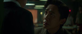 Movie still from “Shang-Chi and the Legend of the Ten Rings” (2021), directed by Destin Daniel Cretton – An older asian man looking up into the air; Close Up shot, Over the shoulder angle