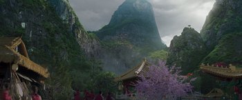 Movie still from “Shang-Chi and the Legend of the Ten Rings” (2021), directed by Destin Daniel Cretton – A group of people standing in front of a mountain; Extreme Wide shot, High angle