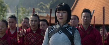 Movie still from “Shang-Chi and the Legend of the Ten Rings” (2021), directed by Destin Daniel Cretton – A group of people standing in front of each other; Close Up shot, Over the shoulder angle